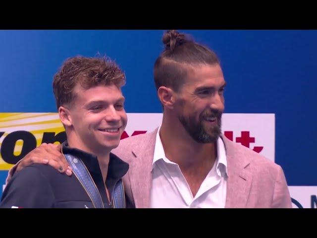 American swimming legend Michael Phelps presents gold as Leon Marchand breaks his world record