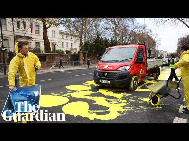 Protesters paint Ukrainian flag outside Russian embassy in London