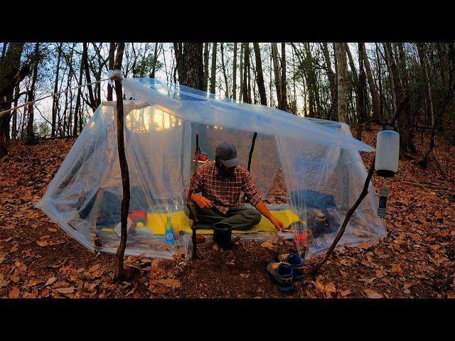 Wild camping while listening to the sound of the dawn rain in a perfect vinyl shelter.