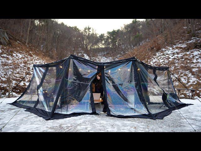 Awning tent camping with urethane windows in the frozen mountains due to strong winds