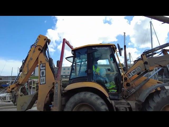 Machine ripping out old lamp post