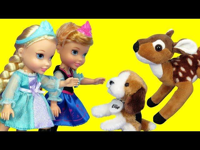 Elsa and Anna toddlers feed cute stuffed animal pets