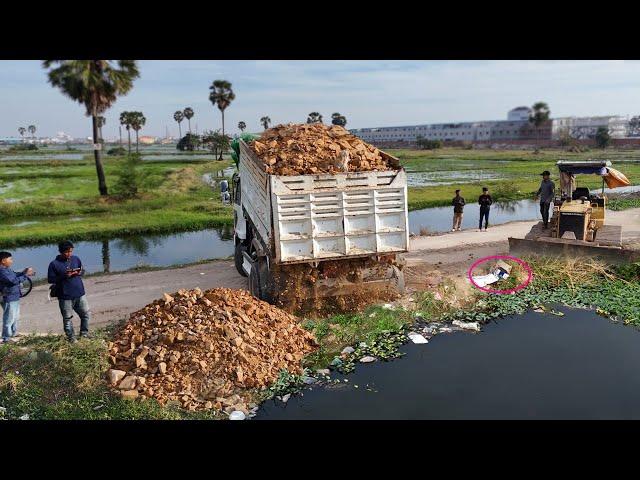 Operator D31P Bulldozer Start project landfill with dump trucks Drop Rock soil