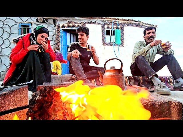 Mohammad and Zulfa cement the roof of the house in the cold mountains with the help of the master