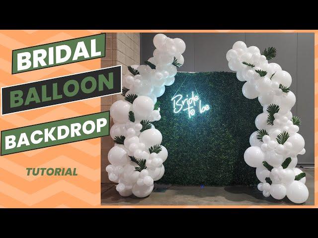 Greenery backdrop with balloons