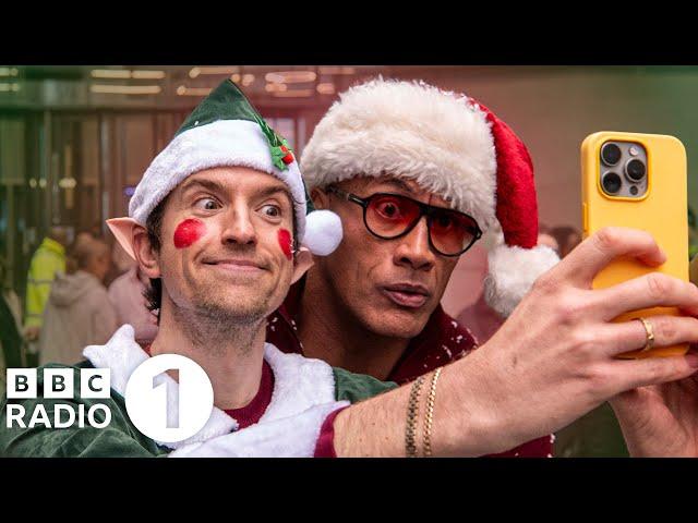 The Rock sings Christmas Carols with Greg James