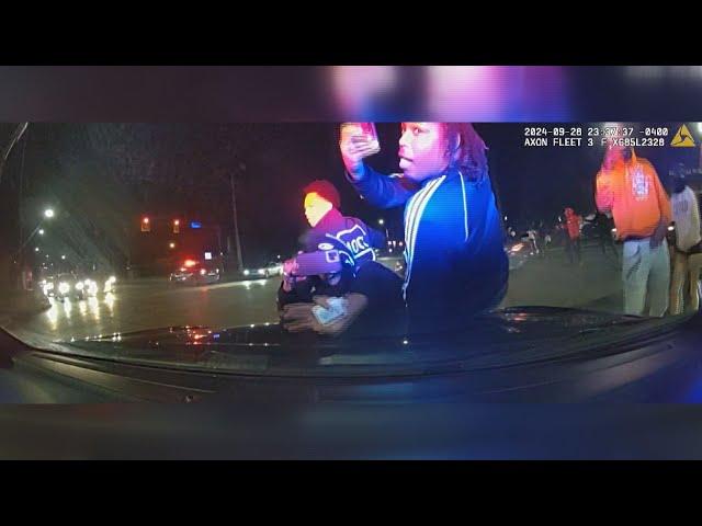 DASHCAM | Street takeover in Cleveland shows people jumping on police officer's hood of car