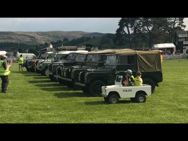 Police Toylander Leads Convoy Of Land Rovers Into Arena At The Welsh Festival Of Land Rovers