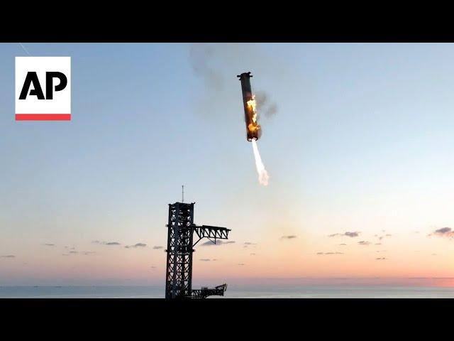 Mechanical SpaceX arms catch Starship rocket booster back at the launch pad