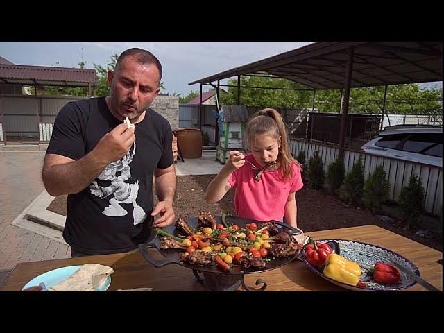 GRILLED MEAT with VEGGIES on a FRYING PAN.