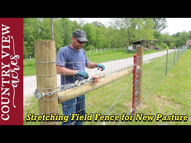 Stretching the first section of field Fence for our new pasture area.