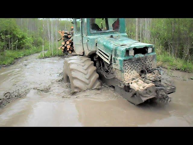 Forestry tractor logging in water and mud