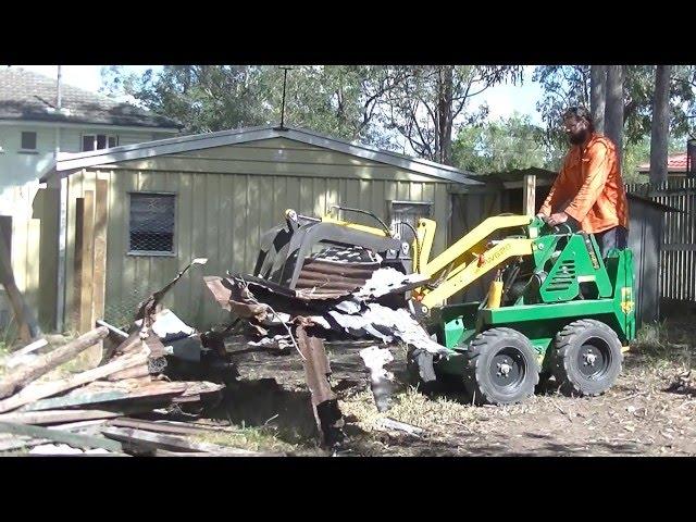 Review our work. Kanga Mini Loader with Log Grapple cleaning up tree stumps and demolition material.