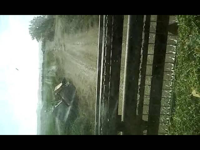 Tractor Hay cutter (Swather) in ditch.