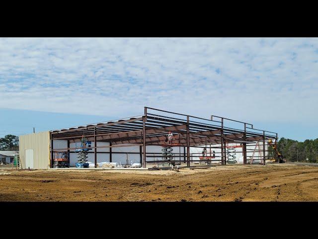 Standing the frame of a red steel building... Day 1