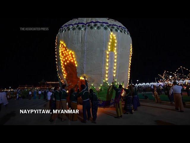 Myanmar briefly forgets deep troubles as giant balloons light up the night skies in annual festival