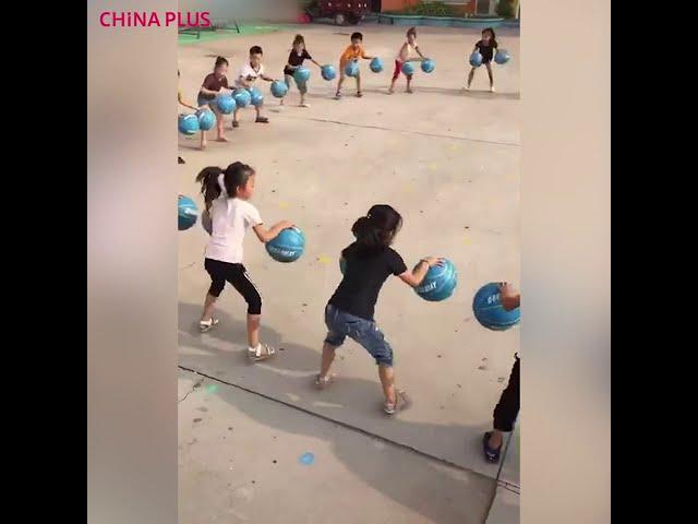 Kindergarten kids master basketball bouncing game