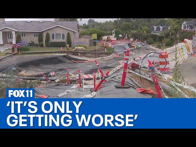 Land movement cracking roads, sinking homes