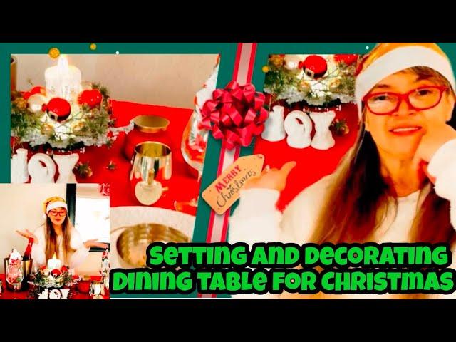 Setting and decorating dining table for Christmas 