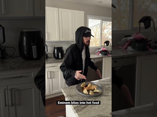 Eminem bites into hot food