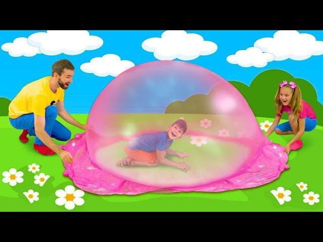 Sasha and Max playing with colorful slime and make huge slime bubble