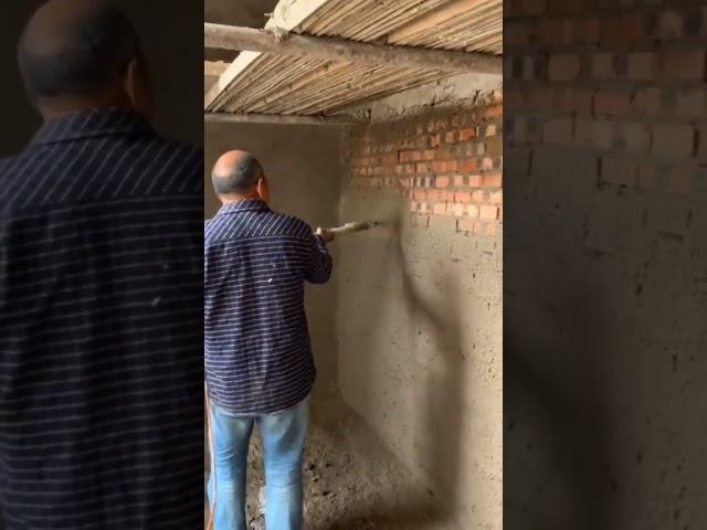 Using a cement mortar spray on the building walls to make the work easier #building #construction