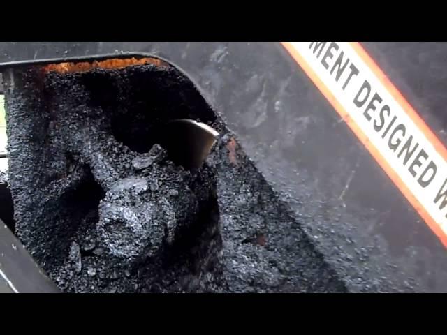 A Paver Placing Base Asphalt - getting it out of the truck onto the road