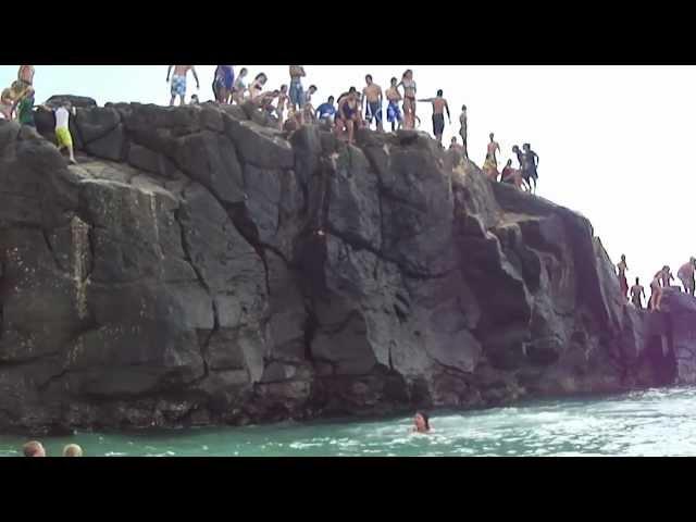 Kelsey's first jump off the Rock at North Shore Beach HI with Casey and Mitchell