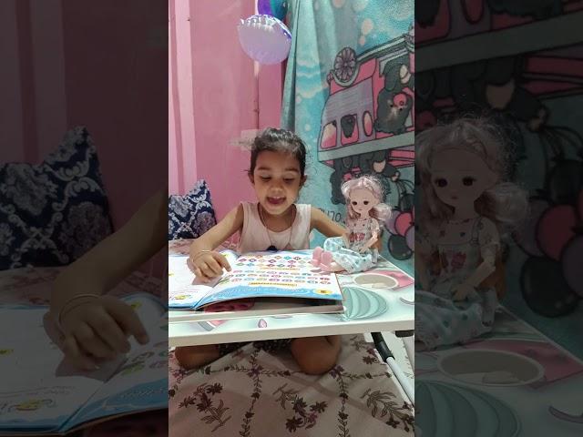 tazu teaching A B C to her doll
