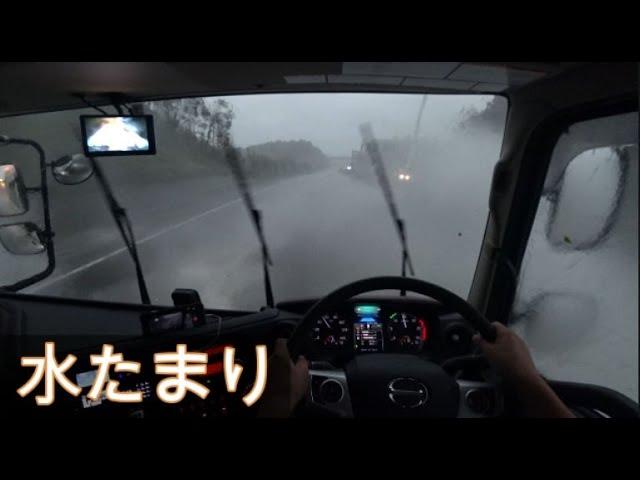 Truck driving on a flooded road.