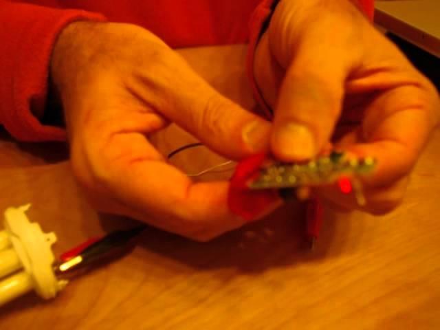 Lighting an 11W 220 V CFL using a 1.5 V AAA battery and a CVS disposable camera flash circuit