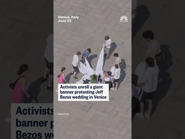 Activists unroll a giant banner protesting Jeff Bezos wedding in Venice