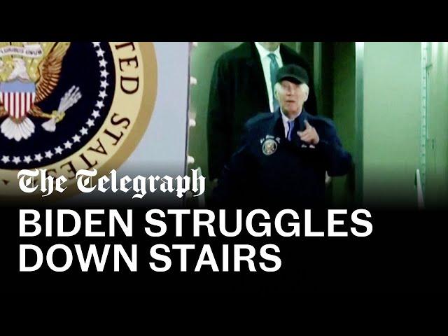 Biden walks slowly down airstairs and pauses several times after Covid diagnosis