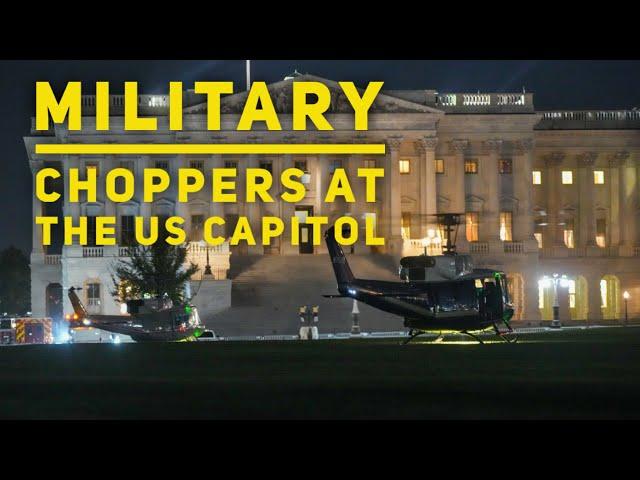 Military and police helicopters land at the US Capitol this evening.