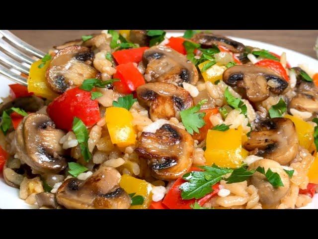Rice with vegetables and mushrooms in a frying pan. Simple and incredibly tasty!