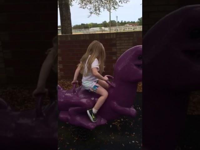 Lily climbing on her favorite  favorite dinosaur