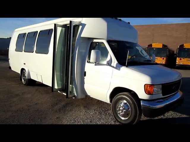 shuttle bus with 23 passenger seats and a rear luggage compartment