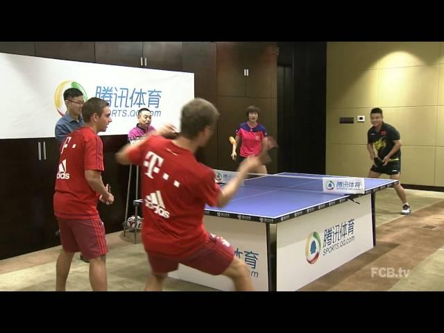 Lahm and Muller playing with ping pong world champions