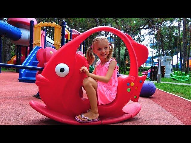 Polina plays on new playground for kids.