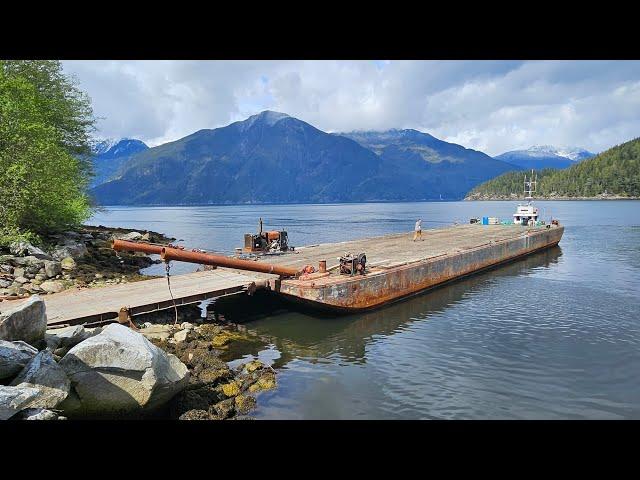 Tugboat built in 1944 the Sea Champ pushing a 120' foot barge out of Toba Inlet.   Empty tankers.