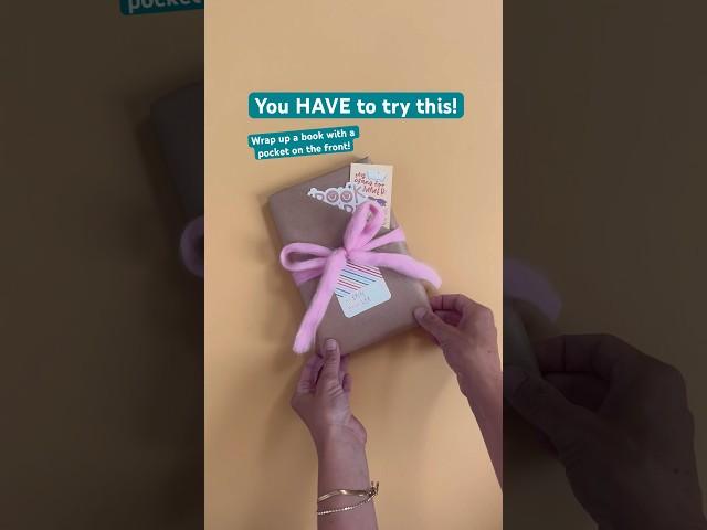 The cutest way to wrap up a book! Fill the pocket with bookish merch  and add a bow and tag!