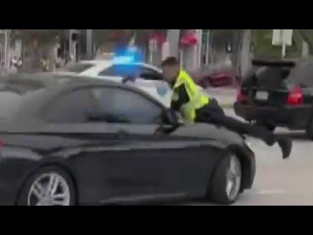 Video shows Miami police officer shooting at driver through windshield of car