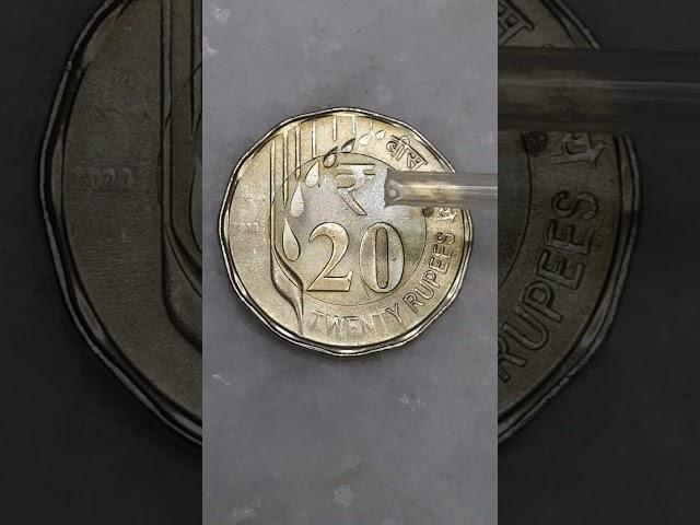 New 20 rupees coin VS water drop.