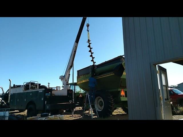 Removing auger from the grain cart to rebuilt the gearbox.