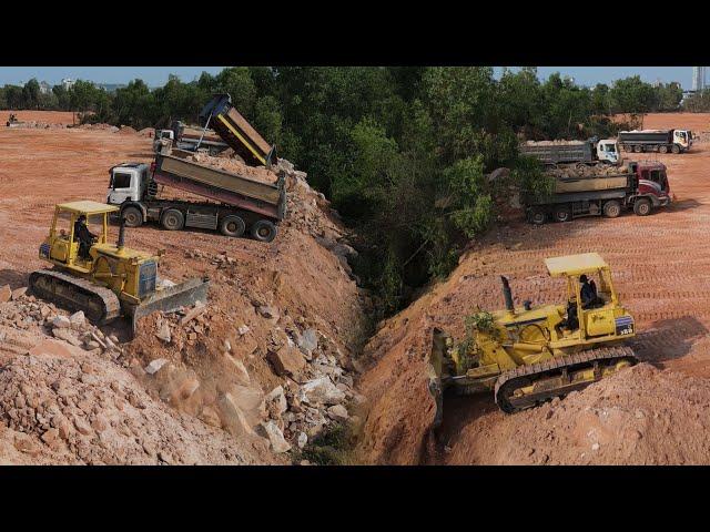 The Best Big Project Equipment Bulldozer Pushing Big Rock Stone and Clear Forestry with Dump Truck