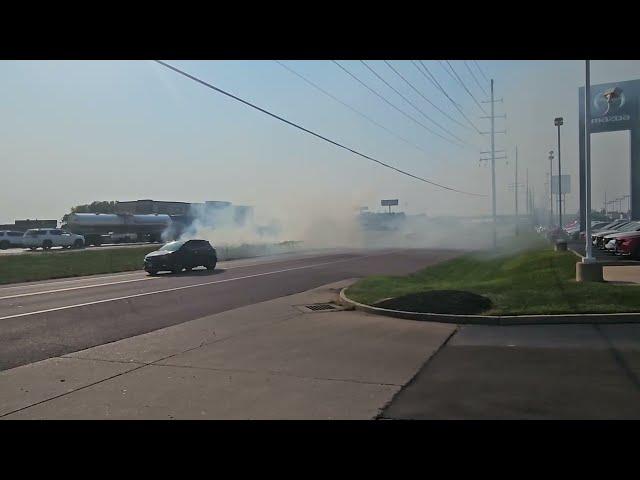 A grass fire breaks out in front of the dealership!