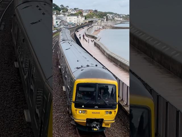 GWR class 166 clattering down the seawall into Kennaway tunnel on the Exmouth service 166208 DMU