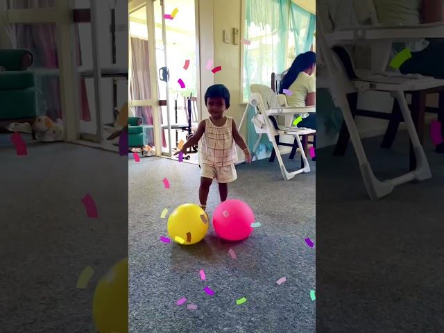 Baby girl lifting 2 balls together. Cute motivational video. Never give up