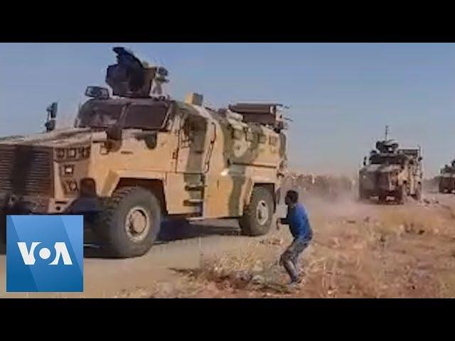 Syrian Kurds Throw Rocks at Passing Turkish Military Convoy in Northern Syria