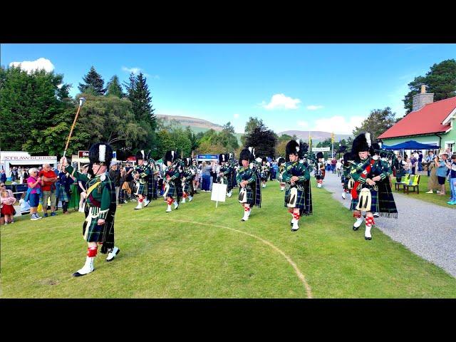 Drum Major leads Huntly Pipe Band playing on march in during 2024 Braemar Gathering in Scotland